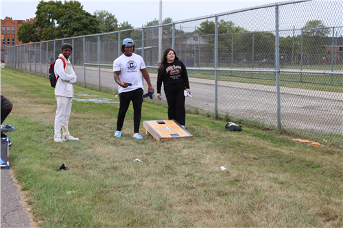 3 people playing toss game